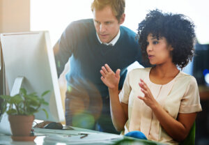 Shot of designers talking together at a workstation