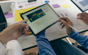 data-driven ux man holds a tablet with analytics