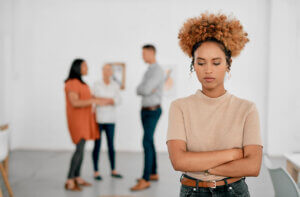 black woman feeling excluded from a small group displays avoiding tokenism in inclusive design