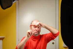 Man framing an image in lockdown at improvised home studio