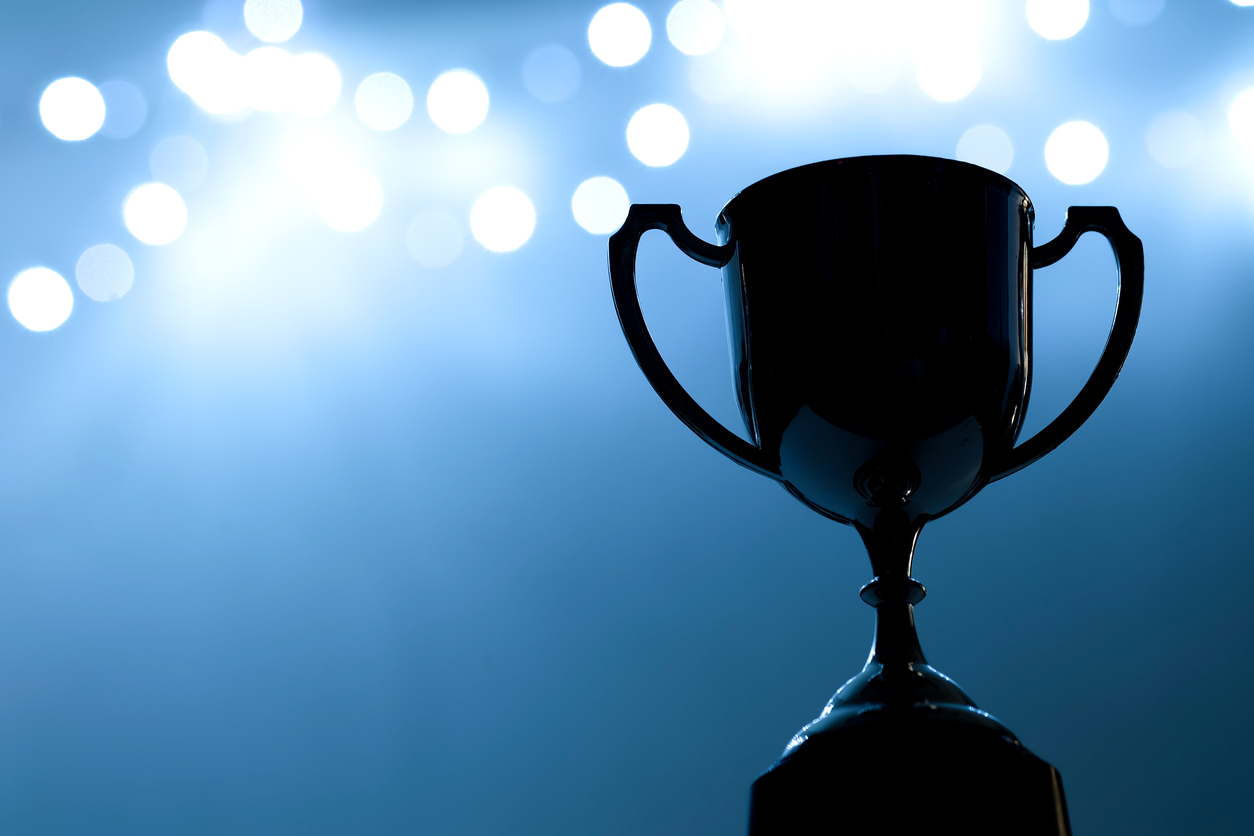 Silver Trophy competition in the dark on the abstract blurred light background with copy space