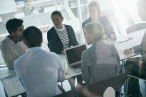 a team of managers discusses UX roles