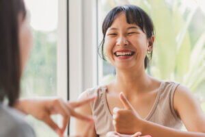 asian woman deonstrates social bonding body language one of five elements of sociability UX.jpg
