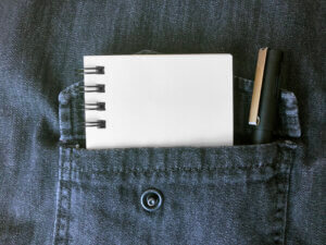 Empty notebook and pencil in shirt pocket demonstrate intangible value.