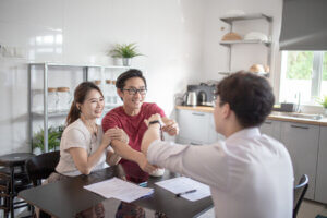 Asian Chinese couple has a moment of truth with a sales rep high five