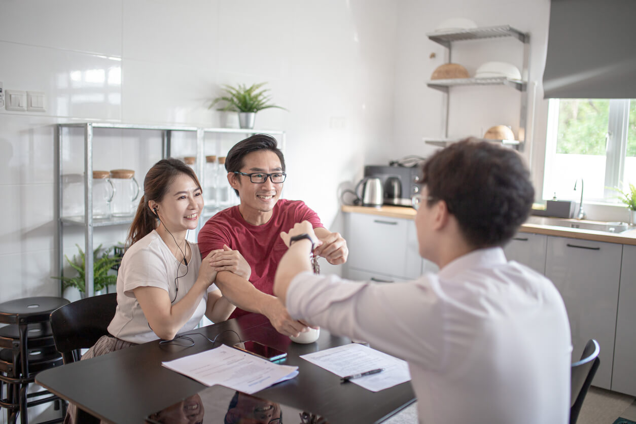 Asian Chinese couple has a moment of truth with a sales rep high five