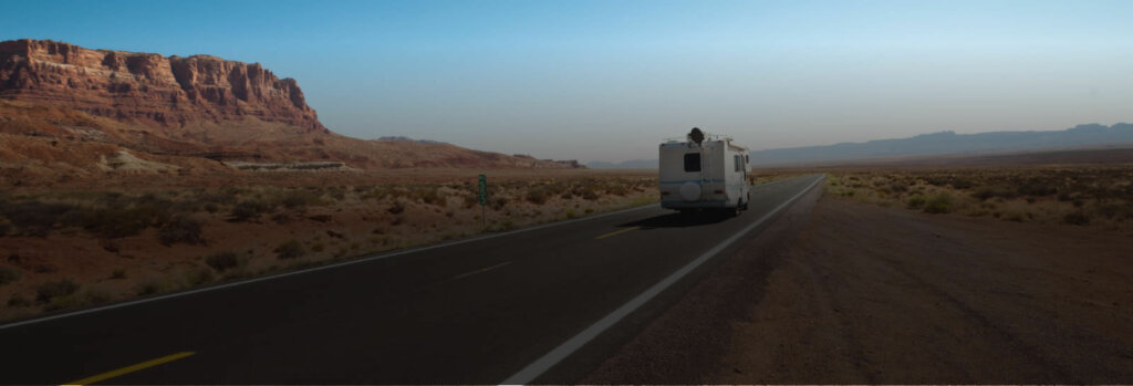 RV drives into sunset