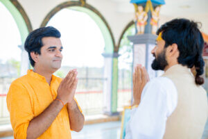 two indian men demonstrate what is sociability with namaste greetings