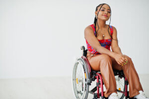 black woman in a wheelchair smiles