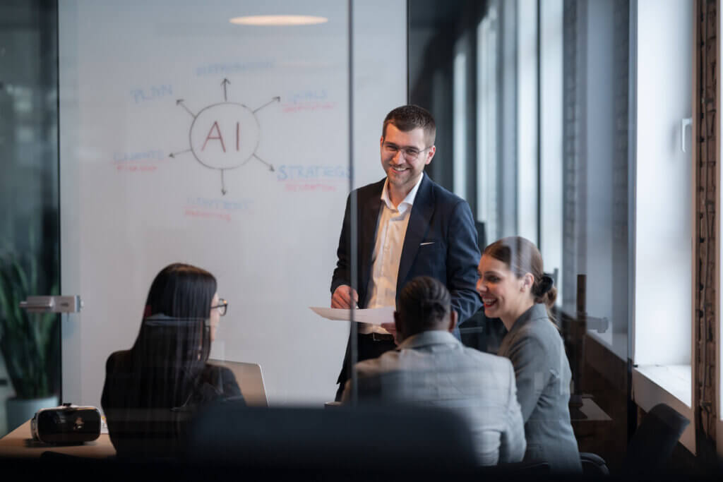 Diverse business team in a modern office during a meeting, discussing artificial intelligence strategy. Concept of AI innovation on white board