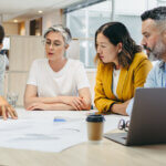 Multicultural designers sharing creative ideas during a meeting in a modern office. Group of innovative businesspeople having a discussion while working on a new project.