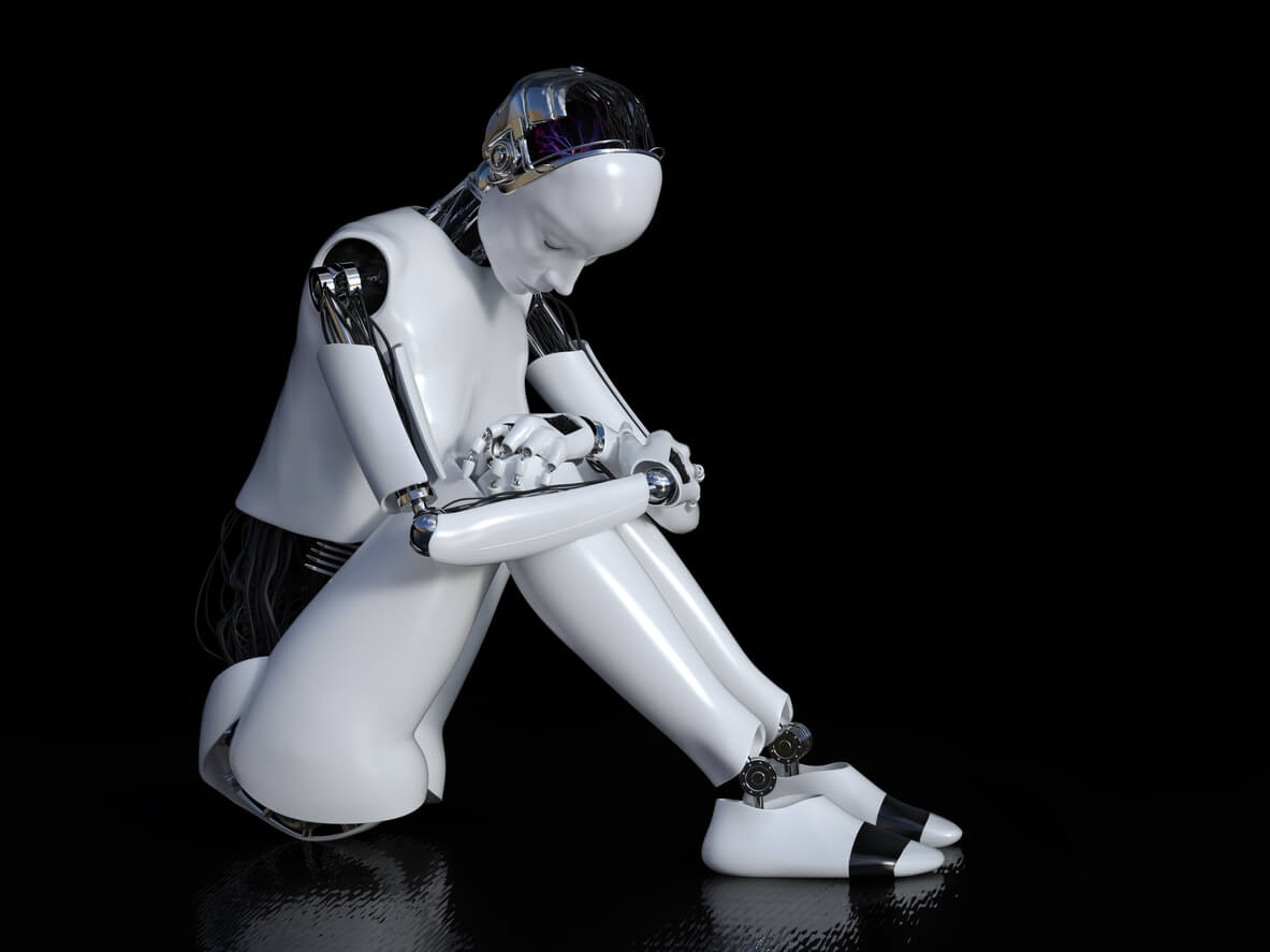 3D robot sitting in solitude on the floor and looking sad or depressed. Black background.